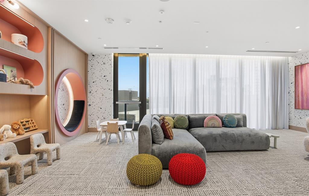 A modern mailroom features rows of brown metal mailboxes, light wood paneling, and marble accents — 3015 S YSABELLA AVENUE UNIT 603, TAMPA, FL