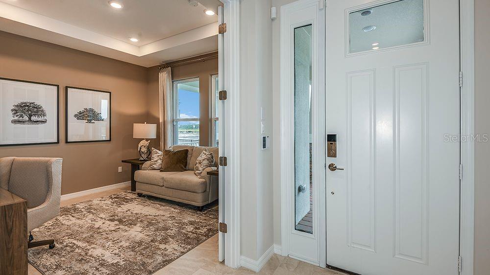 A view from an entryway looking into a home office with a sofa and desk — 617 MOON SHELL CIRCLE, NEW SMYRNA BEACH, FL
