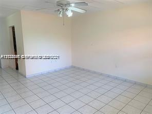 An empty room with white walls, white tile flooring, and a ceiling fan — 4655 Palm Ave # 315, Hialeah FL 33012, HIALEAH, FL