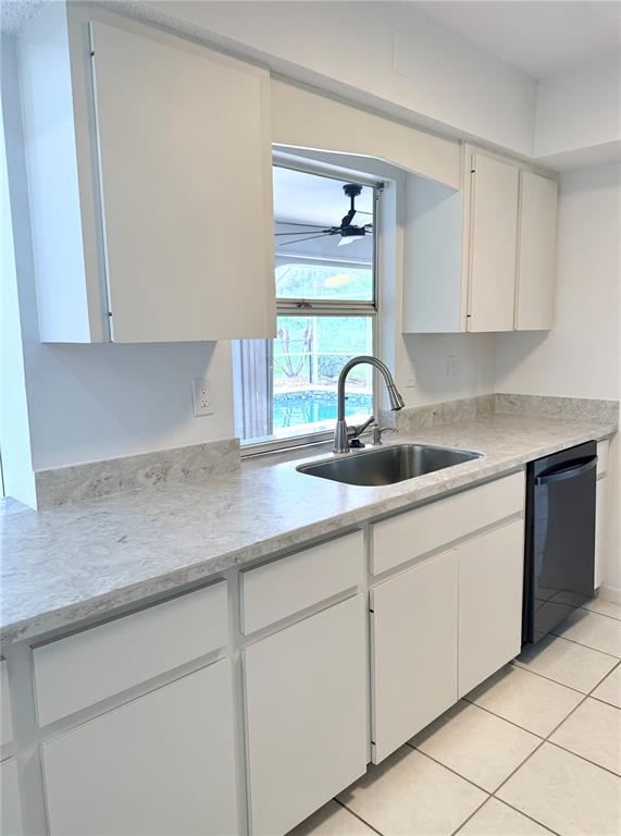 A single-story house with a dark garage door, light exterior walls, and a concrete driveway — 167 MOCHA COURT, PUNTA GORDA, FL