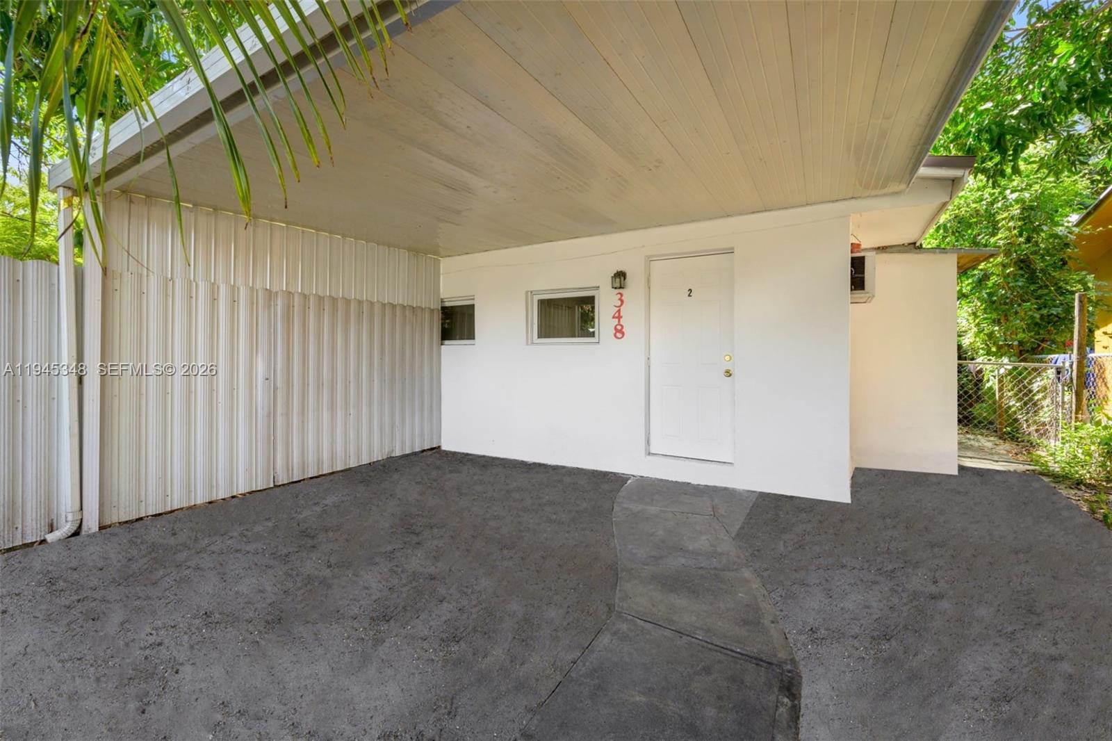A white exterior wall features a door labeled number two under a covered carport — 348 NE 58th St, Miami FL 33137, MIAMI, FL