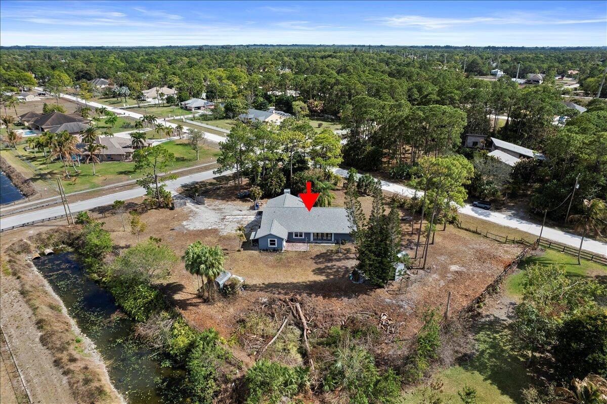 An aerial view of a single-story house with a gray roof on a large lot — 14537 77th Place N, Loxahatchee FL 33470, LOXAHATCHEE, FL