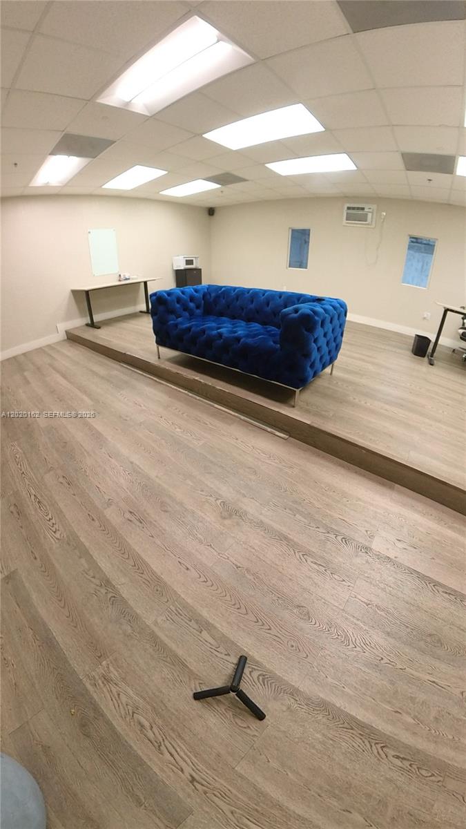 A room with light wood-look flooring, a raised platform, and a blue tufted sofa — 2746 NW 112th Ave # 2746, Doral FL 33172, DORAL, FL