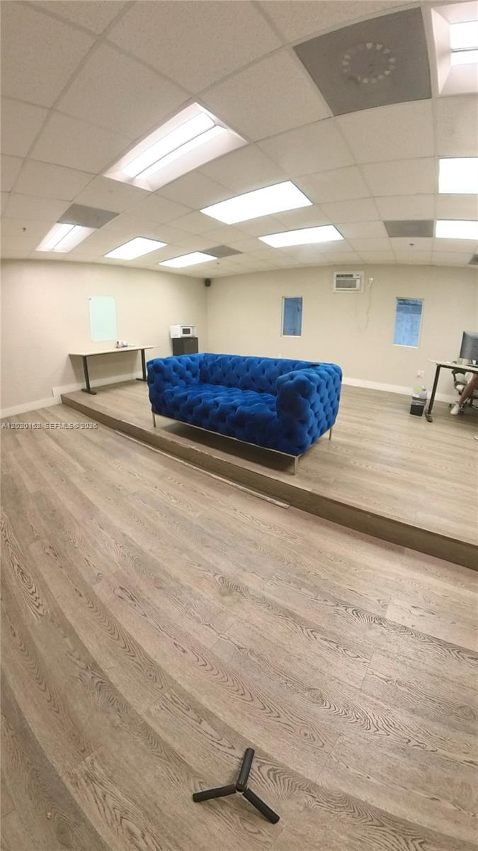 A bright office space features a raised platform with a blue tufted sofa — 2746 NW 112th Ave # 2746, Doral FL 33172, DORAL, FL