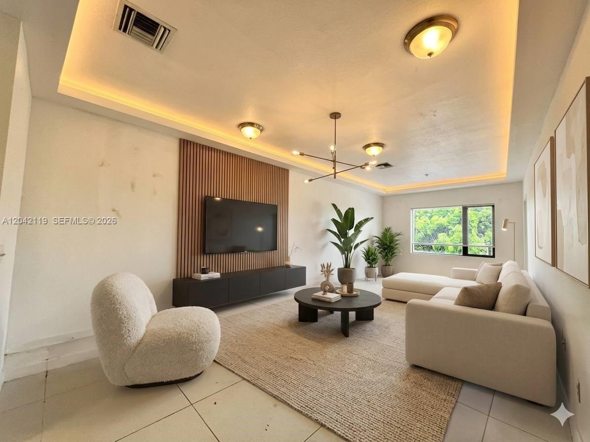 A modern living room features a wood-slat accent wall, a television, and a sectional sofa — 440 E 27th St # 204, Hialeah FL 33013, HIALEAH, FL