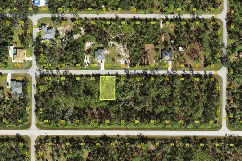 This is an aerial map showing a vacant residential lot highlighted in yellow — 14441 RACOA AVENUE, PORT CHARLOTTE, FL