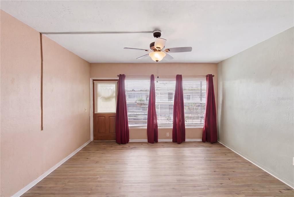 A white front door with a sunflower wreath and a large window with blinds — 4325 58TH WAY N UNIT 1525, KENNETH CITY, FL
