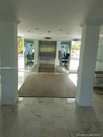 A marble-floored lobby features a central elevator, a large area rug, and white support columns — 2505 S Ocean Blvd # 2070, Palm Beach FL 33480, PALM BEACH, FL
