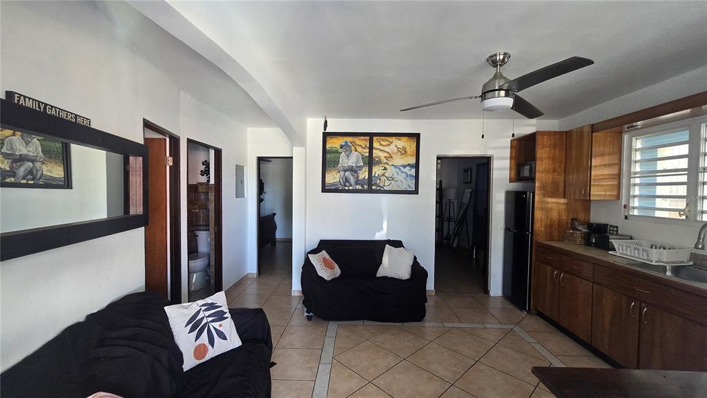 A living room with tile floors, a black sofa, and an adjacent kitchen area — 3 WILLIAM FONT STREET, CULEBRA, PR