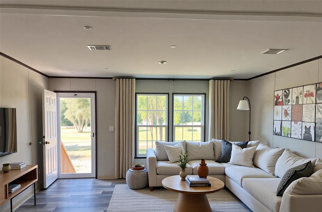 A living room features a sectional sofa, a round coffee table, and a glass-paned door — 10970 NE 109TH STREET, ARCHER, FL