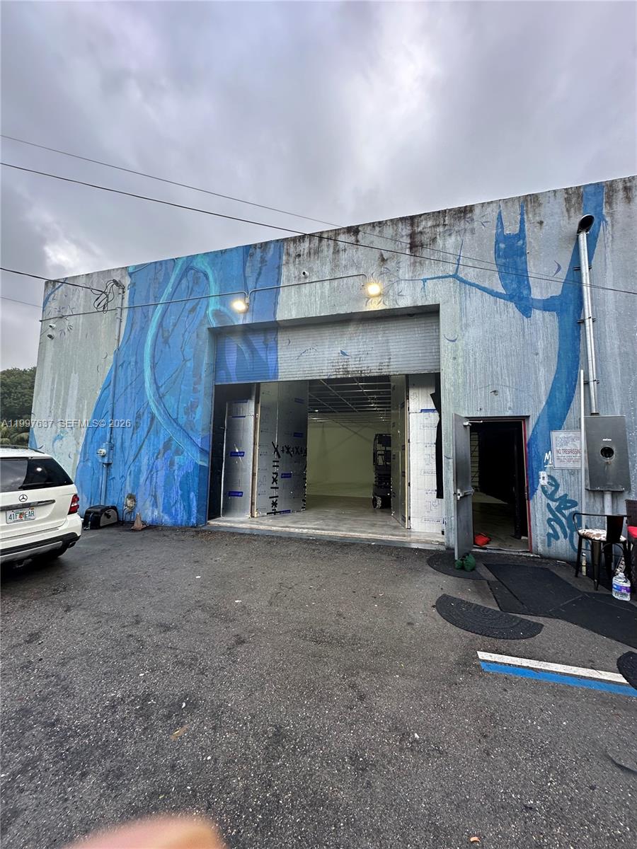 The exterior of a warehouse building features a blue mural and a large open bay — 4151 NW 2nd Ave, Miami FL 33127, MIAMI, FL