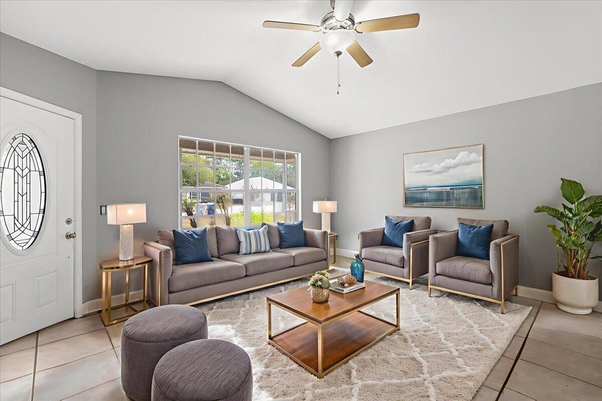A living room features gray walls, a sofa, two armchairs, a coffee table, and tile flooring — 2135 87th Avenue, Vero Beach FL 32966, VERO BEACH, FL