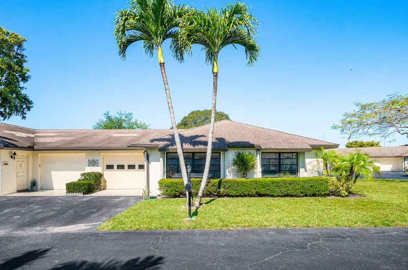 A single-story house with a two-car garage, palm trees, and a manicured lawn — 10120 Eaglewood Terrace # B, Boynton Beach FL 33436, BOYNTON BEACH, FL