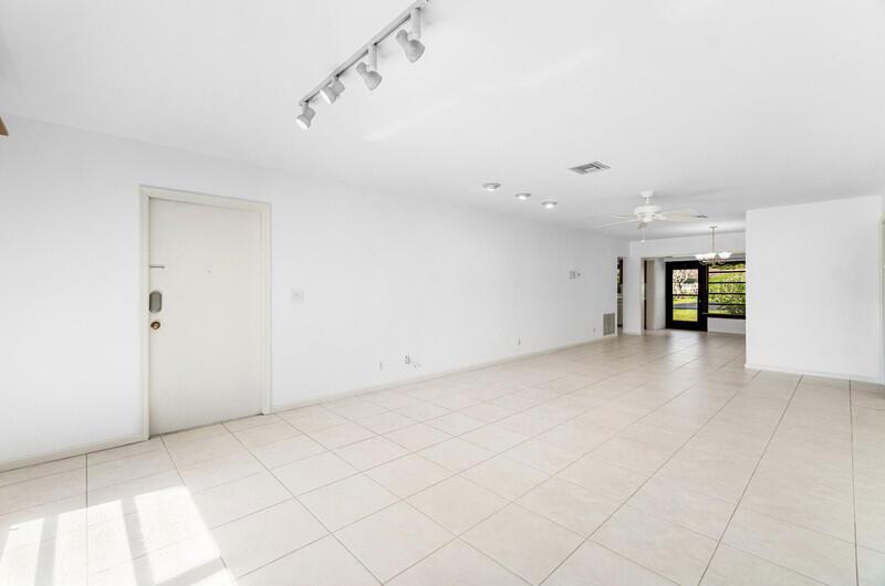 An empty room with white walls, tile flooring, track lighting, and a ceiling fan — 10120 Eaglewood Terrace # B, Boynton Beach FL 33436, BOYNTON BEACH, FL