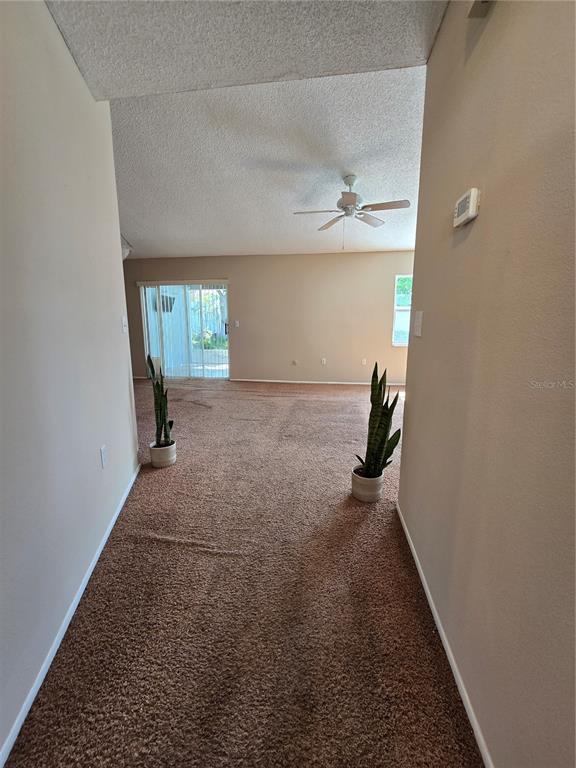 An aerial view shows a purple house with a brown roof and a landscaped yard — 9836 MOREHEAD LANE, PORT RICHEY, FL