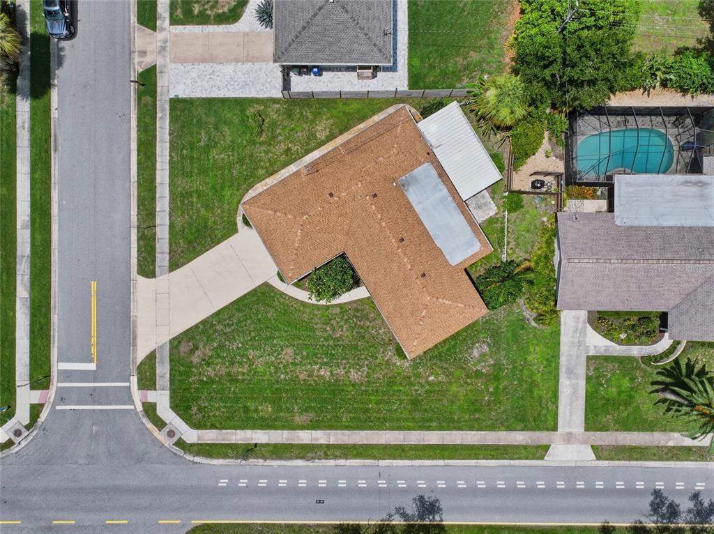 An aerial view shows a house with a brown roof, driveway, and backyard pool enclosure — 2711 GULF GATE DRIVE, SARASOTA, FL