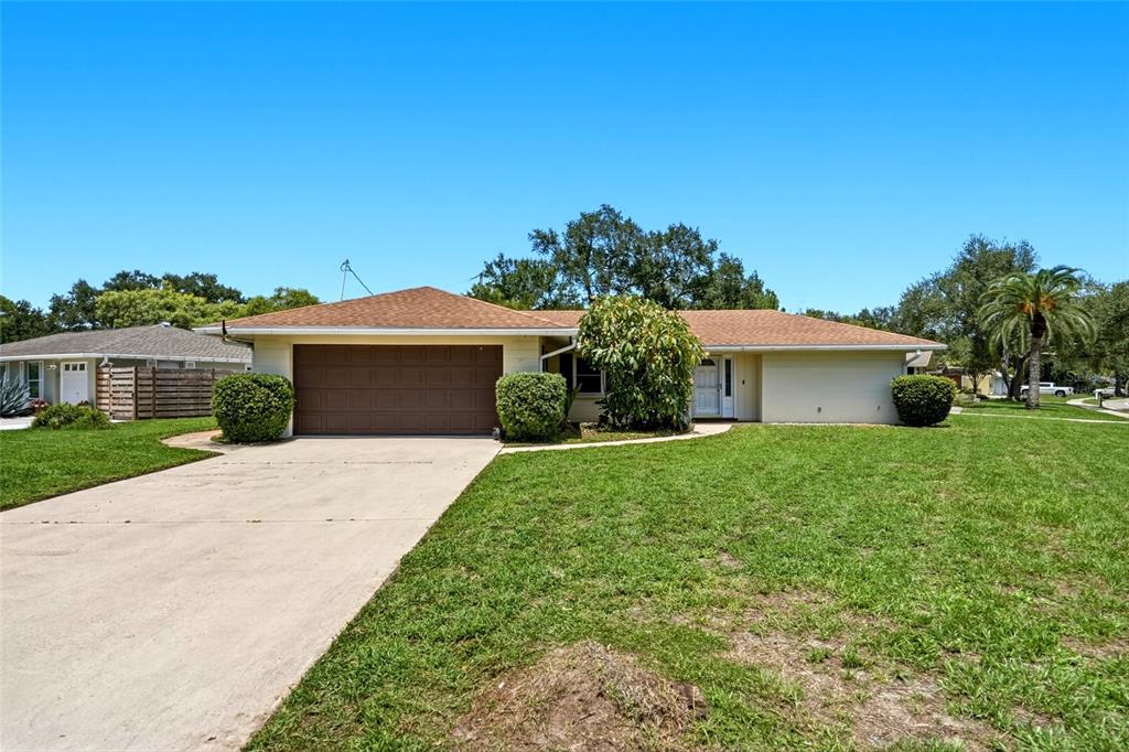 A single-story house with a brown roof, tan exterior, and a two-car garage — 2711 GULF GATE DRIVE, SARASOTA, FL