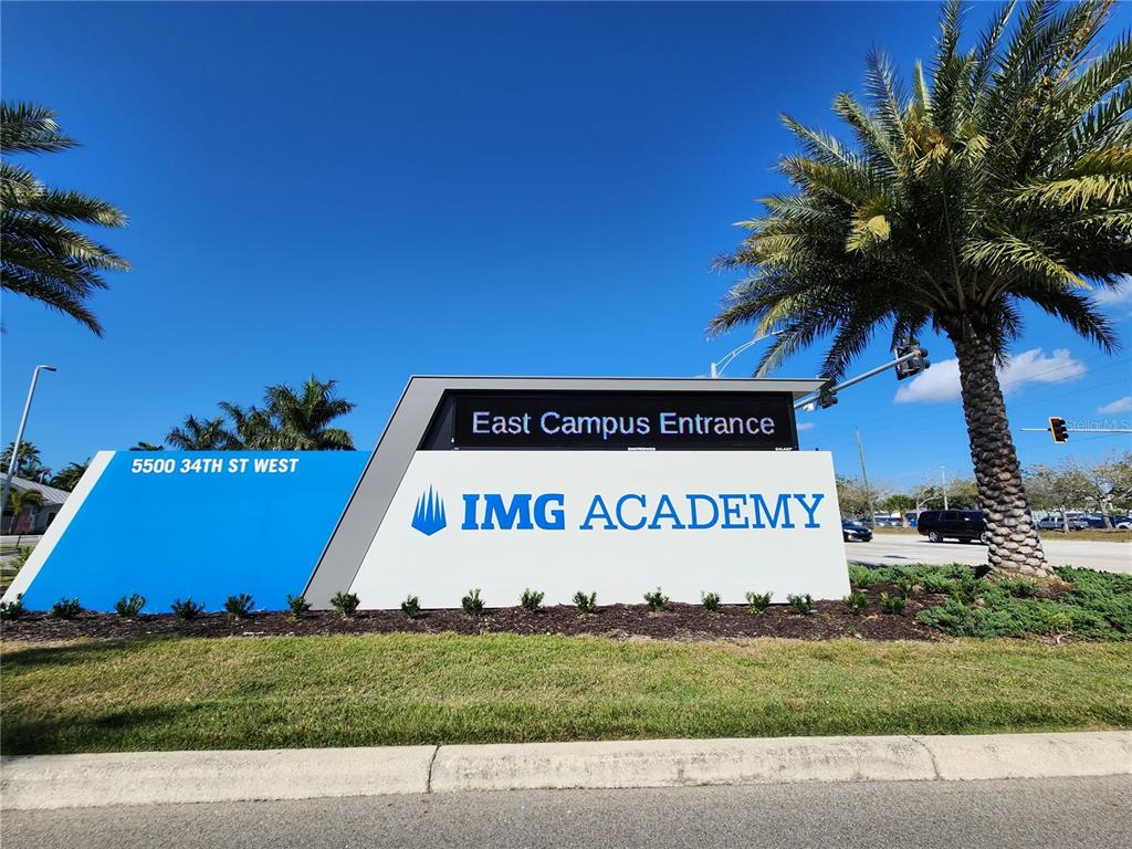 A large sign for the IMG Academy East Campus stands near a palm tree — 3701 54TH DRIVE W UNIT M203, BRADENTON, FL