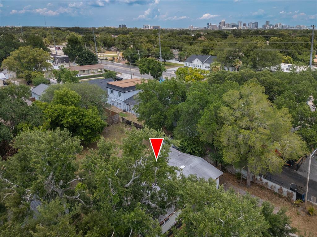 An aerial view shows a residential lot with a house partially obscured by large trees — 2702 S SHINE AVENUE, ORLANDO, FL