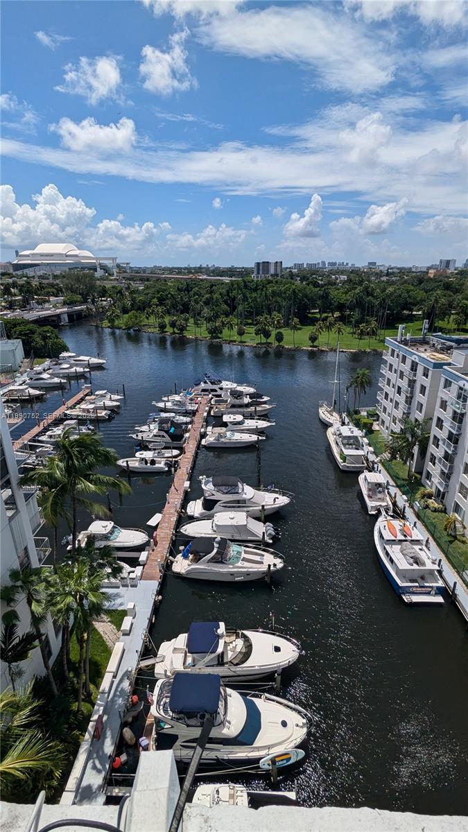 An elevated view of a marina filled with docked boats next to a residential building — 1700 NW North River Dr, Miami FL 33125, MIAMI, FL