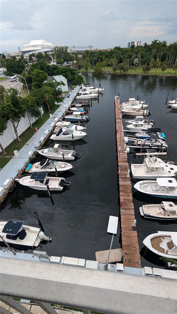 An elevated view shows a marina with numerous boats docked along wooden piers — 1700 NW North River Dr, Miami FL 33125, MIAMI, FL