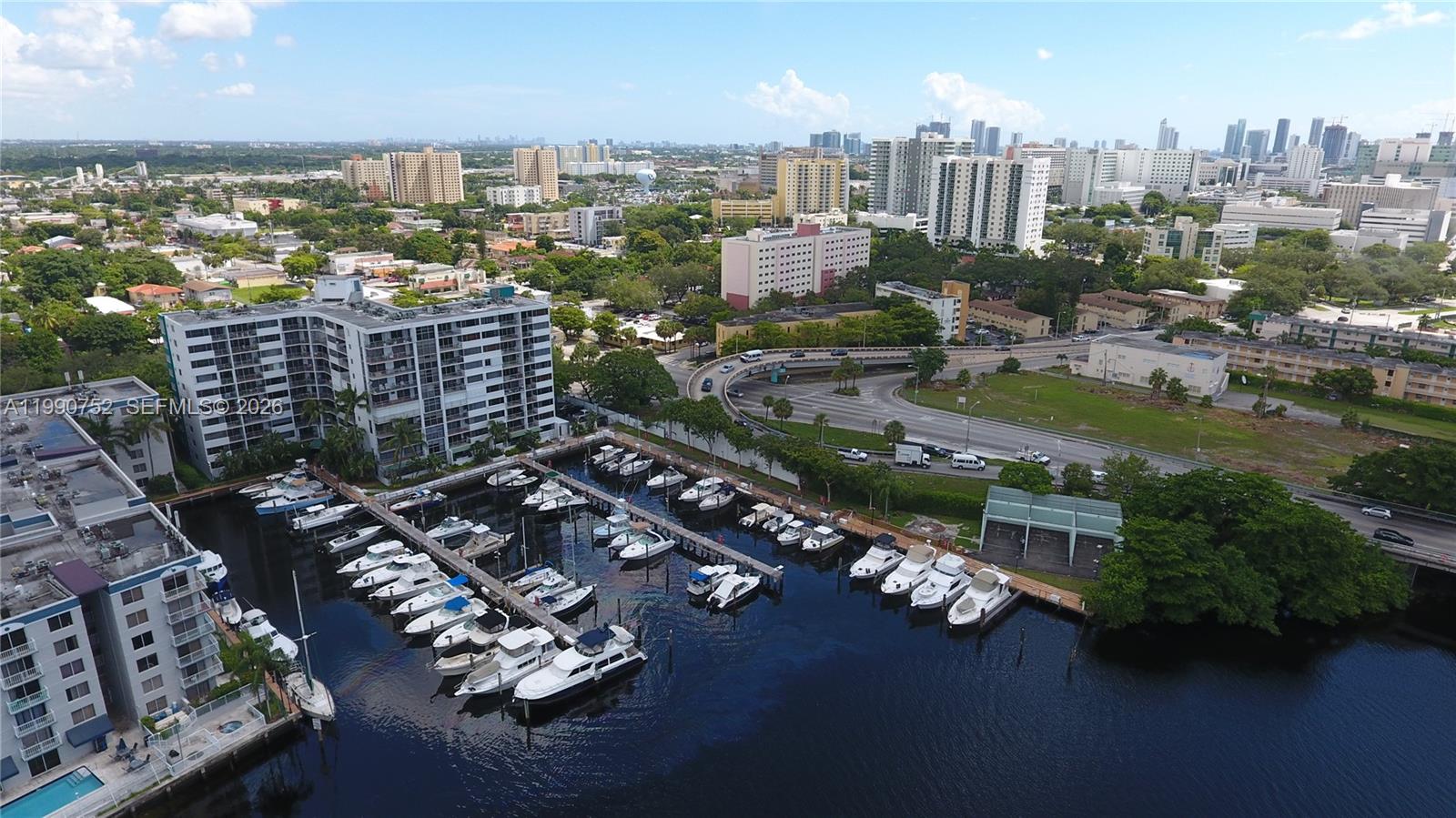 An aerial view shows a marina with docked boats next to a large apartment complex — 1700 NW North River Dr, Miami FL 33125, MIAMI, FL