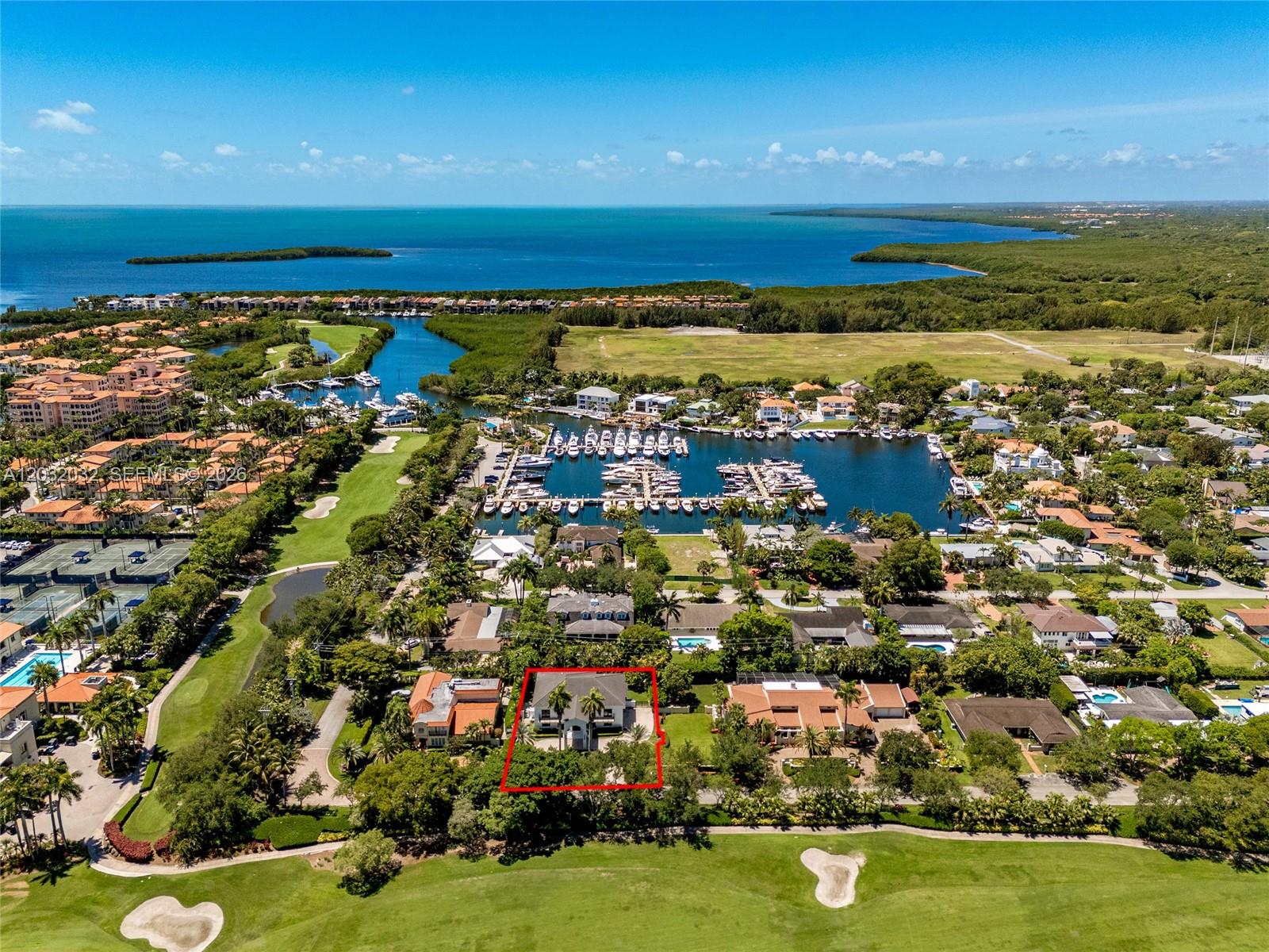 An aerial view shows a house outlined in red, situated next to a golf course — 6220 SW 144th St, Coral Gables FL 33158, CORAL GABLES, FL
