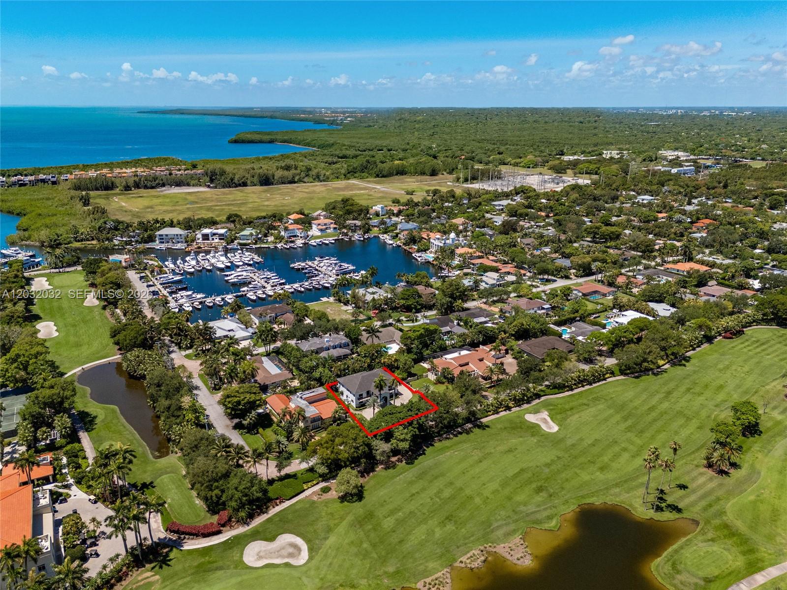 An aerial view shows a house outlined in red, situated beside a golf course — 6220 SW 144th St, Coral Gables FL 33158, CORAL GABLES, FL