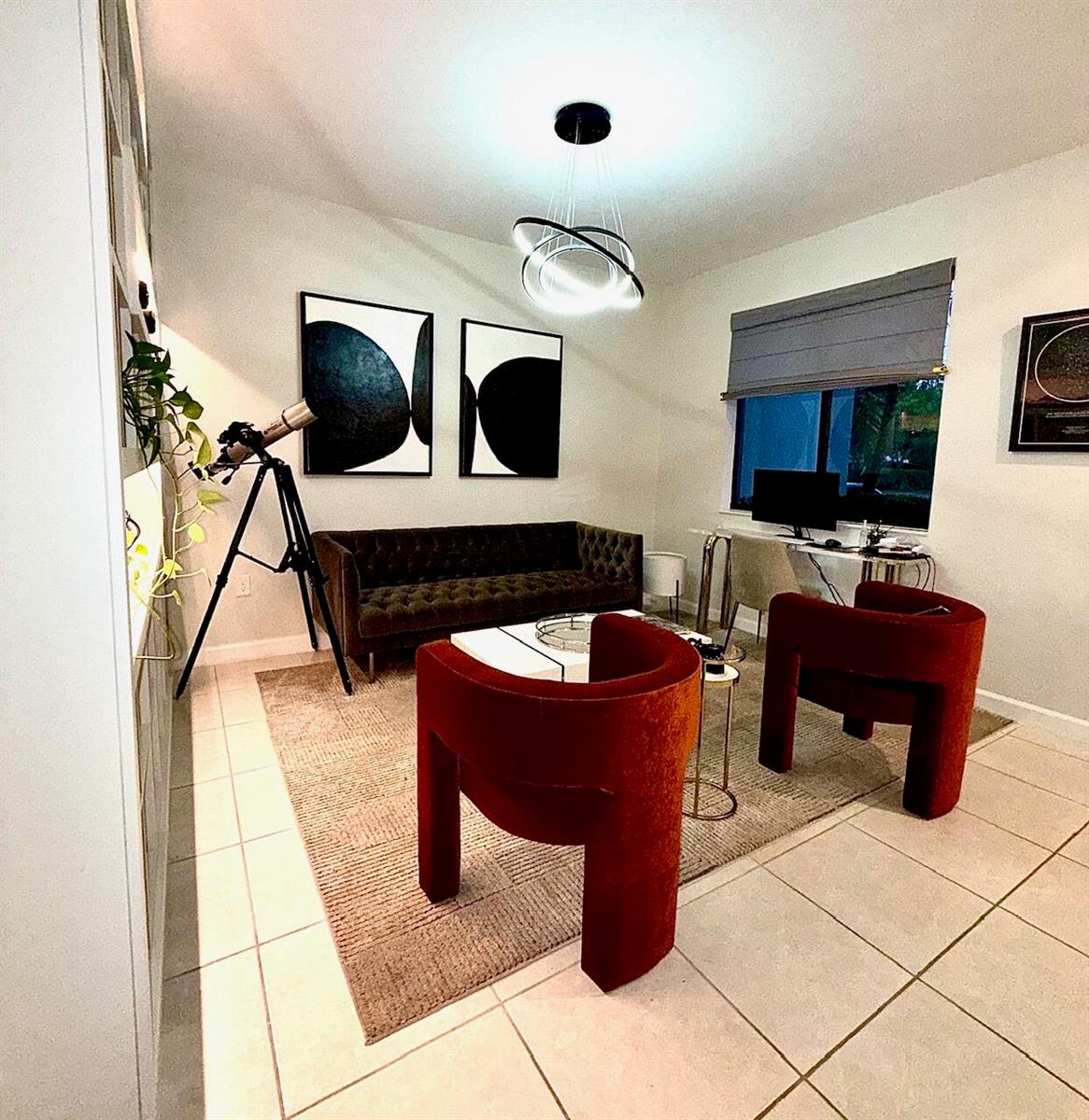 A living room features a tufted sofa, two red armchairs, a telescope, and modern lighting — 21423 NE 2nd Place, Miami FL 33179, MIAMI, FL