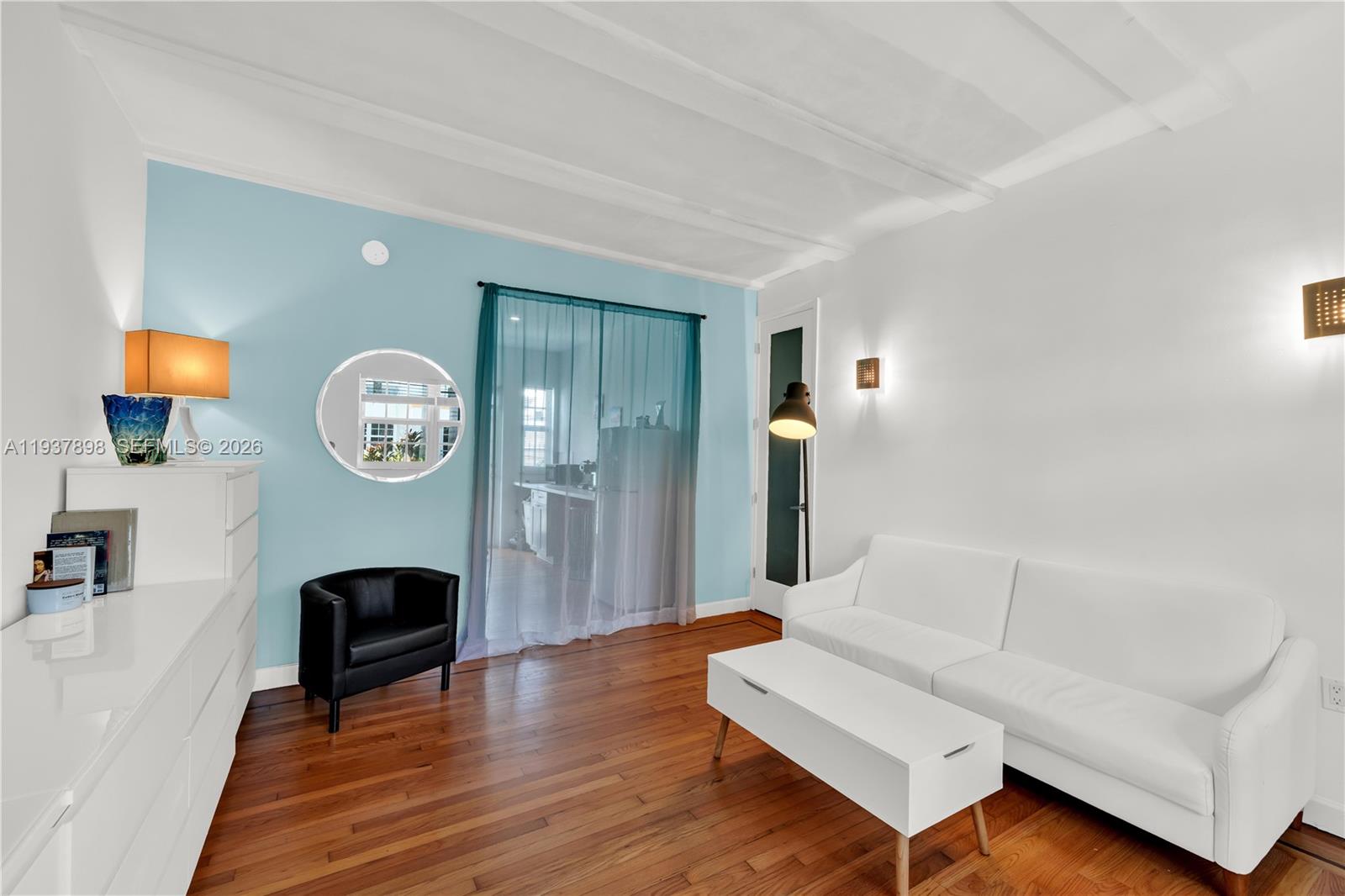 A living room features a white sofa, a black armchair, and a light blue accent wall — 439 15th St # 2, Miami Beach FL 33139, MIAMI BEACH, FL