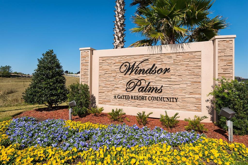 A stone monument sign for Windsor Palms resort community sits behind a bed of flowers — 8100 PRINCESS PALM LANE UNIT 203, KISSIMMEE, FL