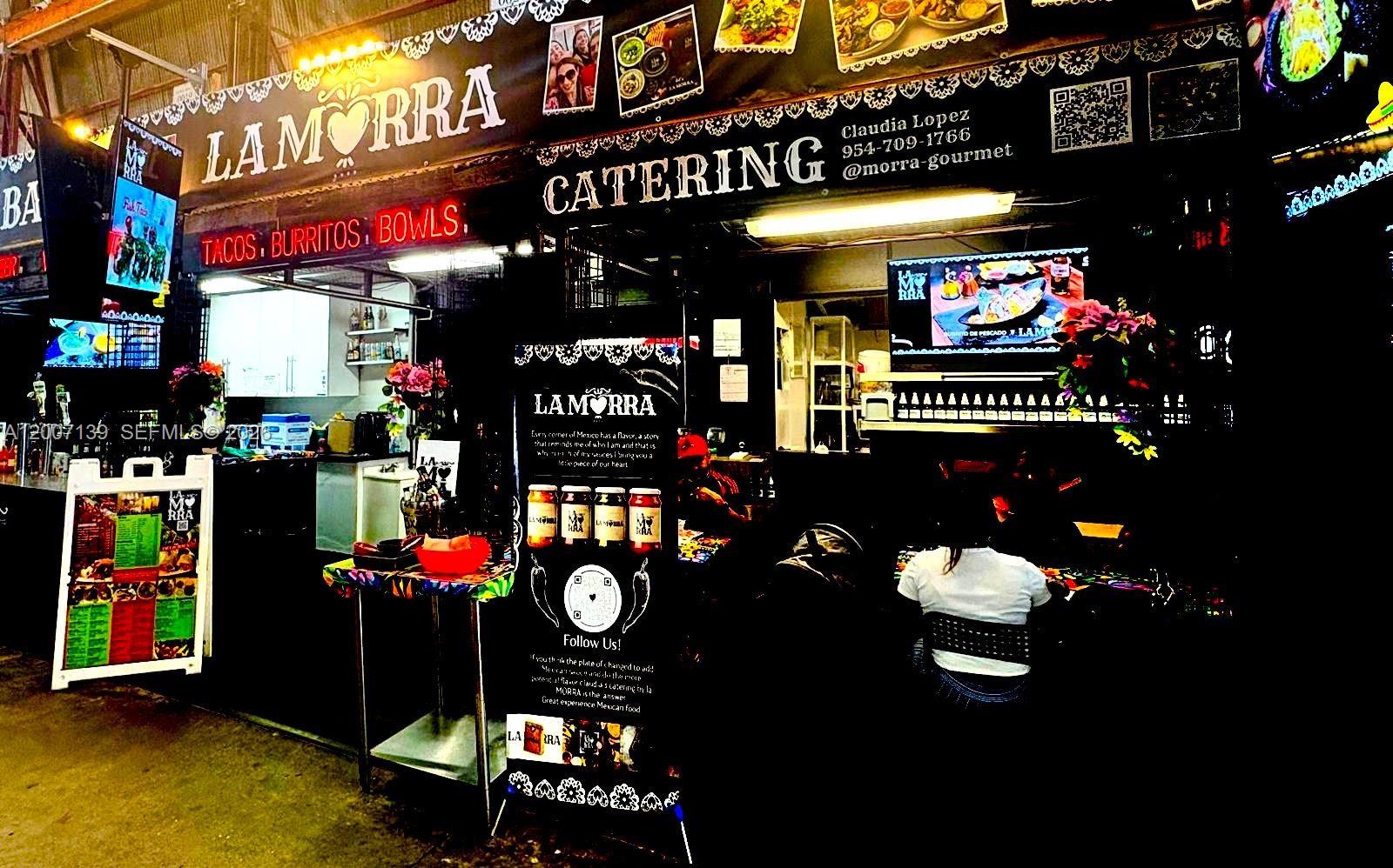 A food stall features a La Morra catering sign, menu boards, and a standing display — E Sheridan, Hollywood FL 33021, HOLLYWOOD, FL