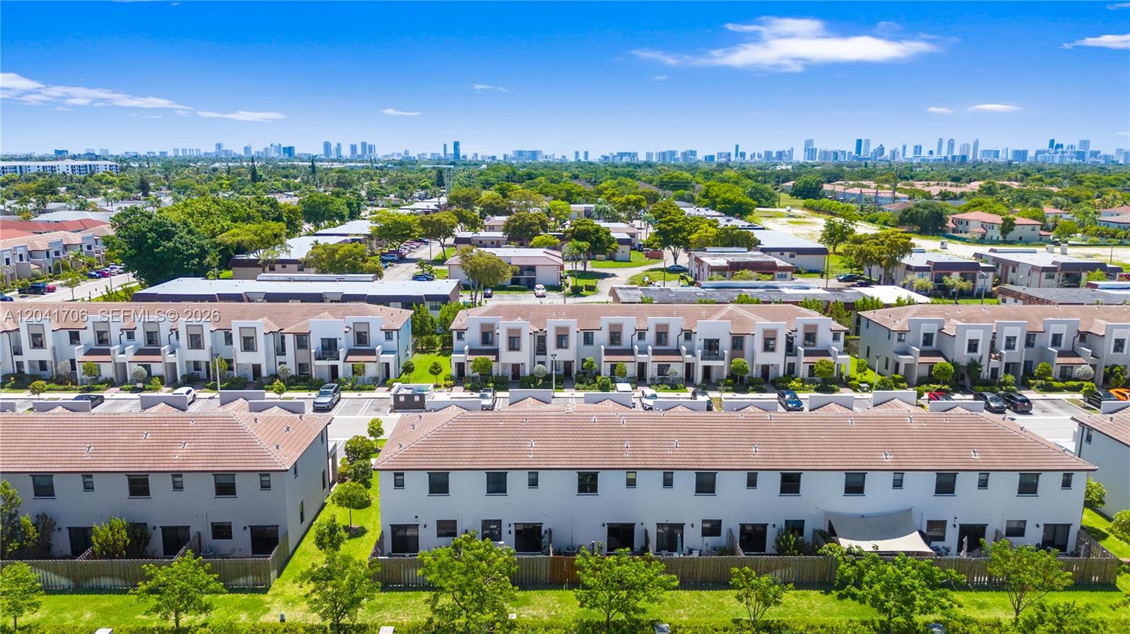 An aerial view shows multiple rows of two-story townhouses with brown tiled roofs — 21018 NE 8th Ave # 21018, Miami FL 33179, MIAMI, FL