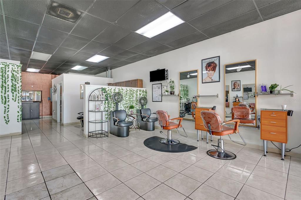 A hair salon features tiled floors, two styling stations with mirrors, and hooded hair dryers — 1903 E FL 60 UNIT D, VALRICO, FL