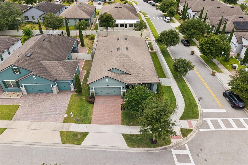 An aerial view shows two suburban houses with paved driveways and green lawns — 1168 NARCOOSSEE DEL SOL, ST CLOUD, FL