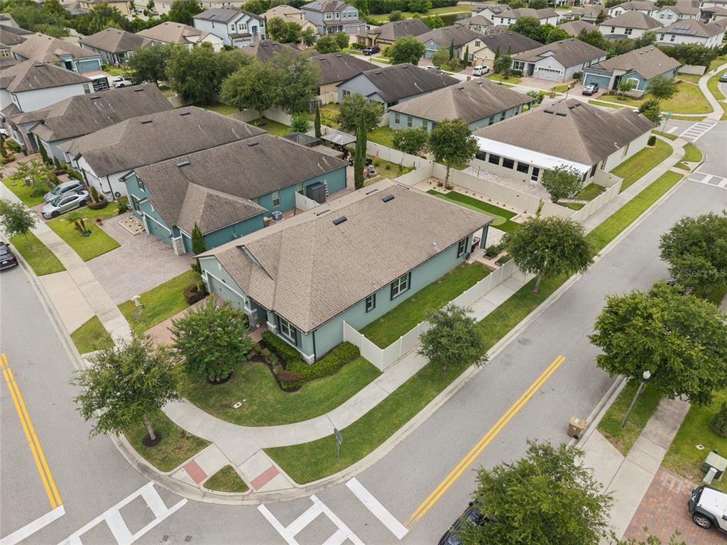 An aerial view shows a corner lot with a single-story house and a fenced yard — 1168 NARCOOSSEE DEL SOL, ST CLOUD, FL