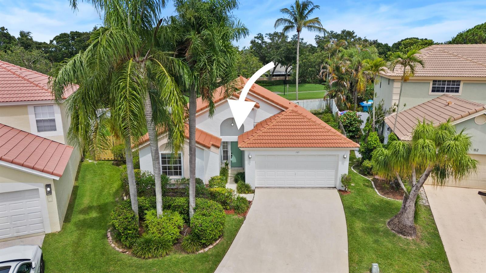 An aerial view of a single-story house with a tiled roof, garage, and front entrance — 165 St Michaels Court, Jupiter FL 33458, JUPITER, FL