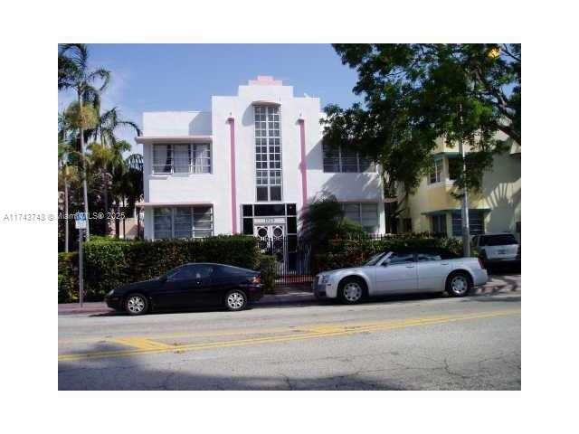 A white Art Deco building stands behind a hedge with two cars parked in front — 1525 Meridian Ave # 104, Miami Beach FL 33139, MIAMI BEACH, FL