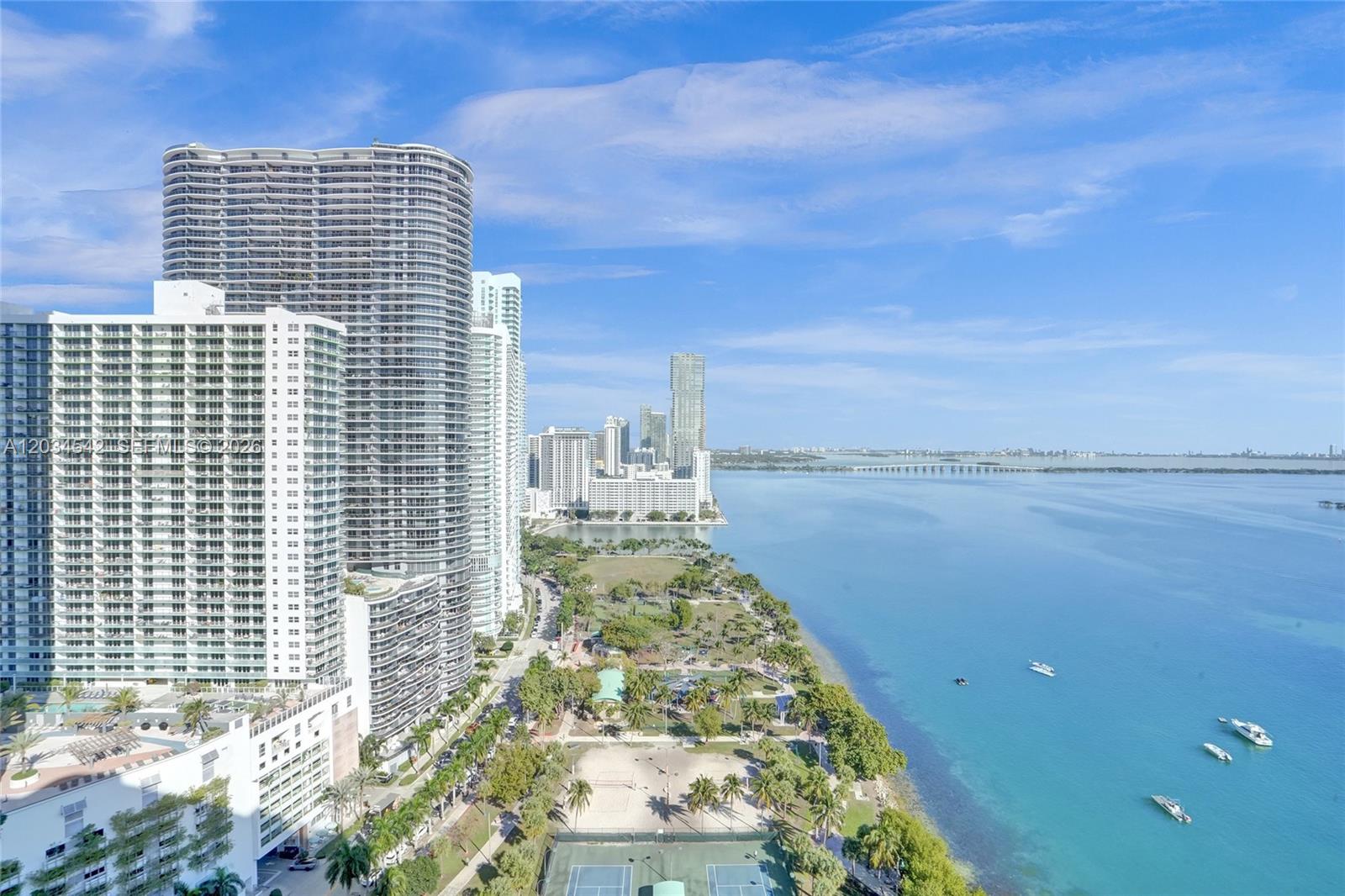 An elevated view of a coastal city skyline, a park, and a blue bay — 1717 N Bayshore Dr # 3646, Miami FL 33132, MIAMI, FL
