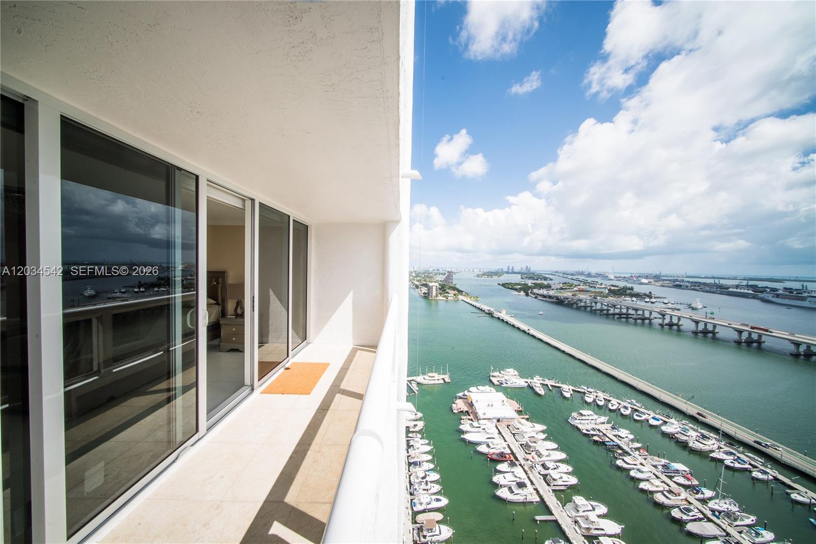 A high-rise balcony overlooks a marina and a bridge spanning a body of water — 1717 N Bayshore Dr # 3646, Miami FL 33132, MIAMI, FL