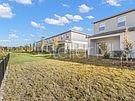 An empty living room with light gray walls, tile flooring, a ceiling fan, and a staircase — 23330 PAPYRUS WAY, LUTZ, FL