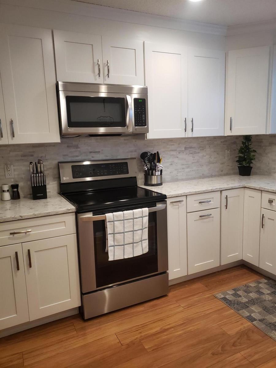 A kitchen with white cabinets, stainless steel appliances, and light-colored countertops — 6021 SE Landing Way Bldg 2 Unit #2 Bldg 2, Stuart FL 34997, STUART, FL