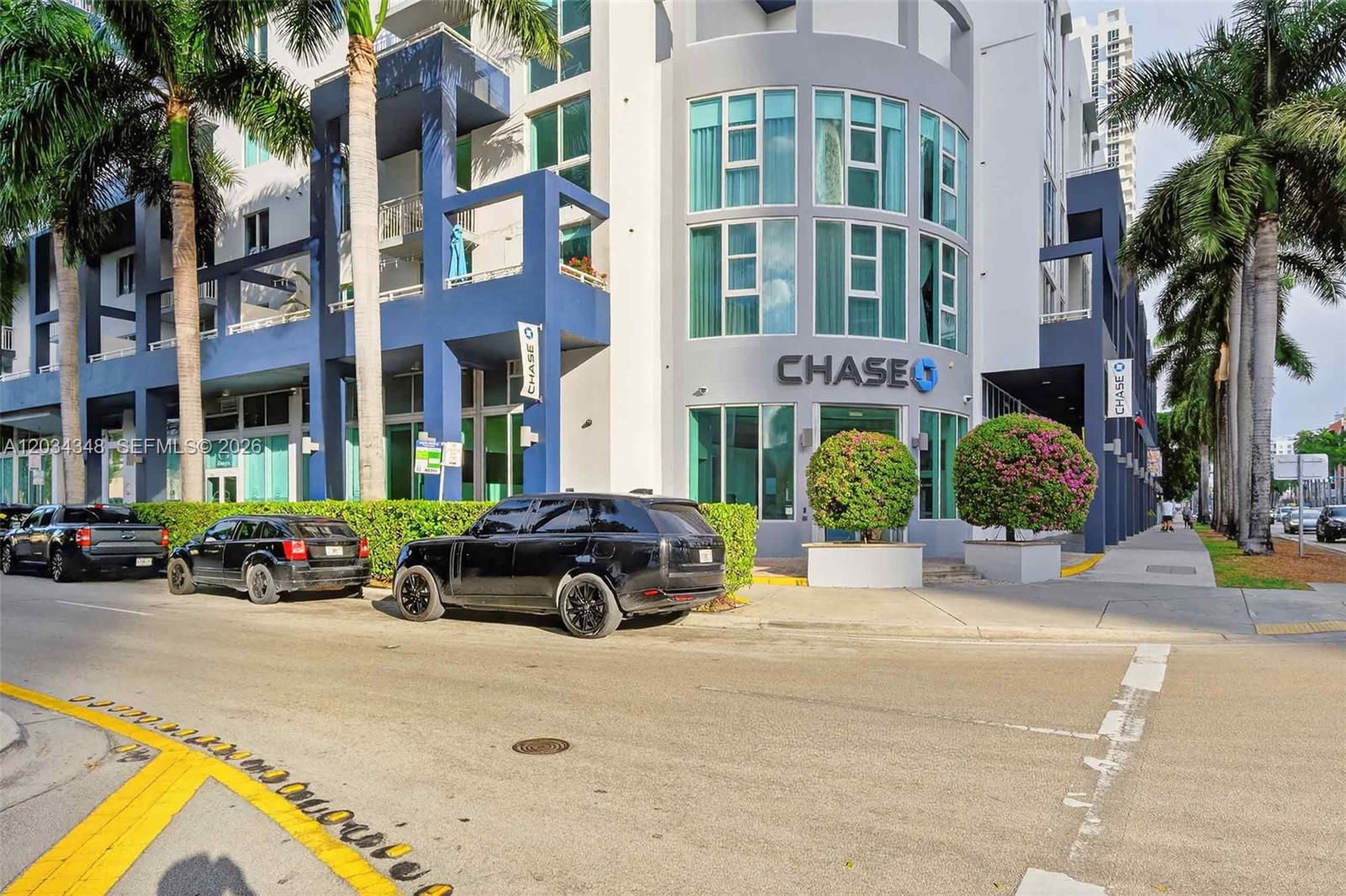 A street-level view of a Chase bank branch located in a modern multi-story building — 275 NE 18th St, Miami FL 33132, MIAMI, FL