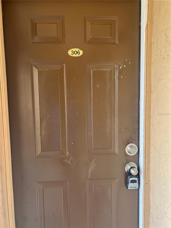 A brown door labeled 306 features a deadbolt and a Master lockbox — 5213 VIA HACIENDA CIRCLE UNIT 306, ORLANDO, FL