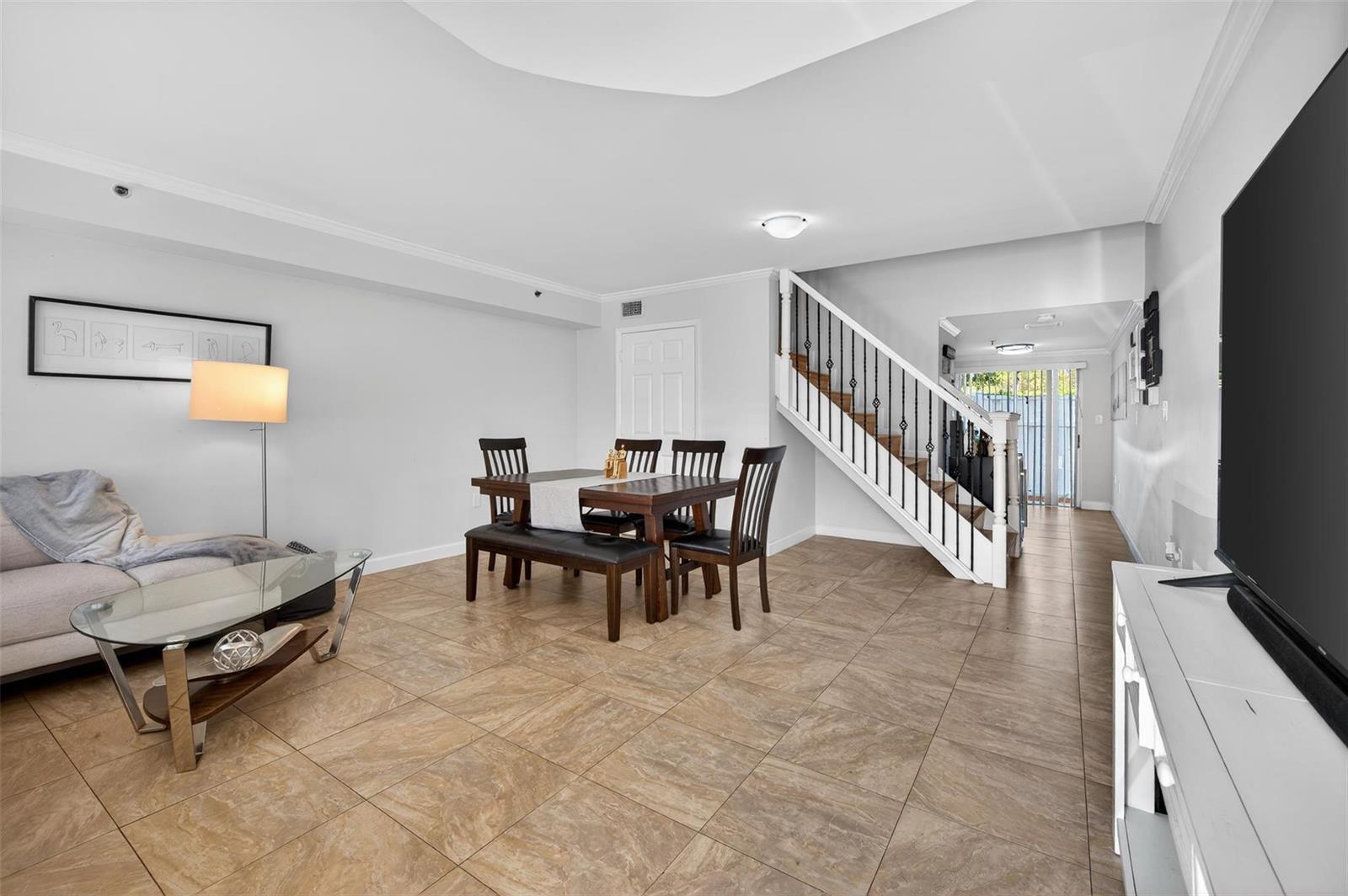 A living and dining area with tile floors, a staircase, and a glass coffee table — 245 Riviera Circle # 245, Weston FL 33326, WESTON, FL
