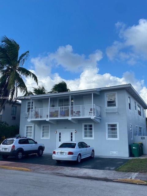 A two-story light blue apartment building with a balcony and two parked cars — 701 82nd St # 1, Miami Beach FL 33141, MIAMI BEACH, FL