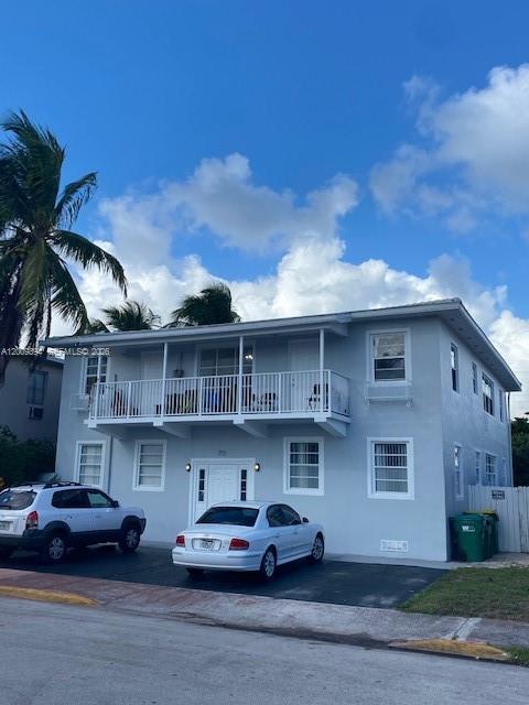 A two-story light blue apartment building features a second-floor balcony and two parked cars — 701 82nd St # 1, Miami Beach FL 33141, MIAMI BEACH, FL
