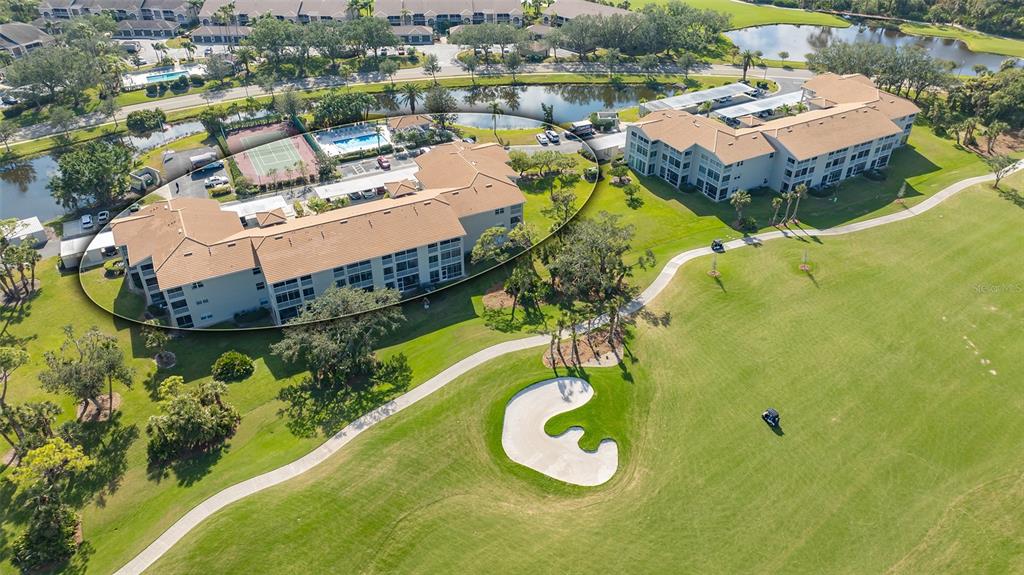 An aerial view shows two multi-story apartment buildings situated next to a golf course — 9610 CLUB SOUTH CIRCLE UNIT 4302, SARASOTA, FL