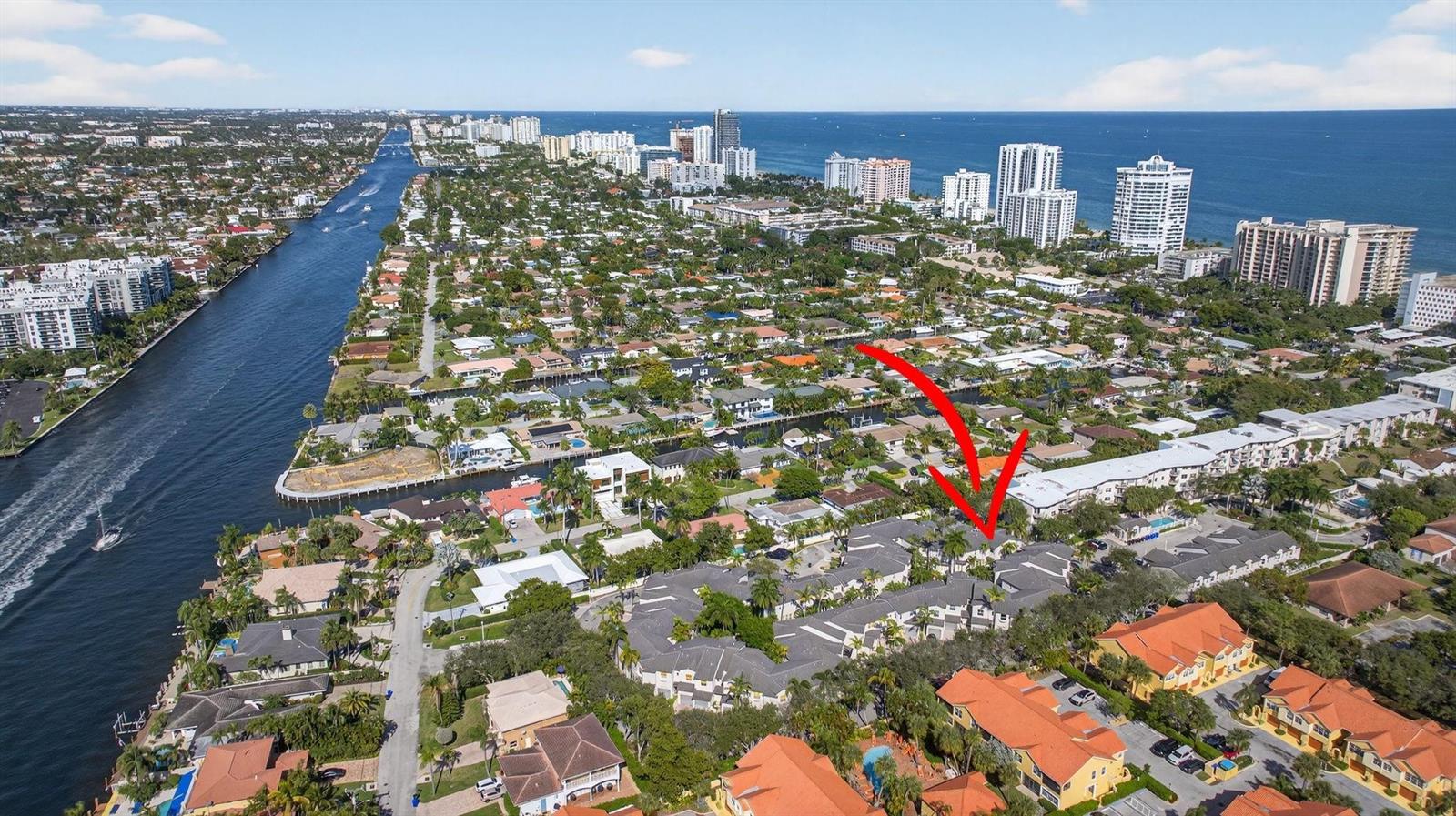 An aerial view shows a residential neighborhood with a red arrow pointing toward a complex — 1900 Oceanwalk Lane # 138, Pompano Beach FL 33062, POMPANO BEACH, FL
