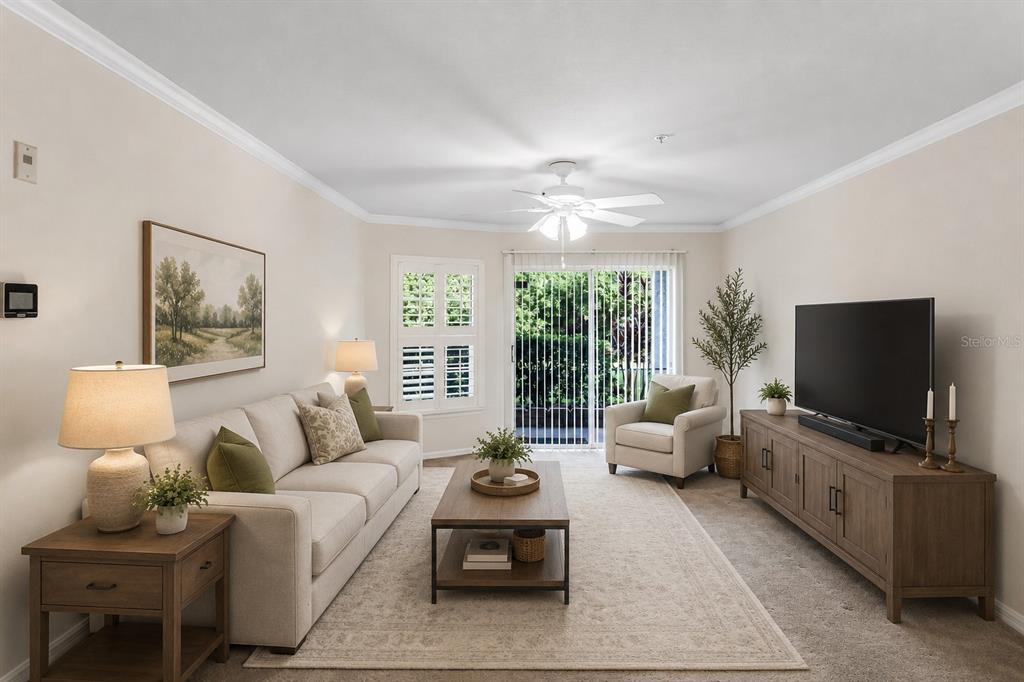 A living room with a beige sofa, coffee table, armchair, and television on a wooden console — 18108 PEREGRINES PERCH PLACE UNIT 7110, LUTZ, FL
